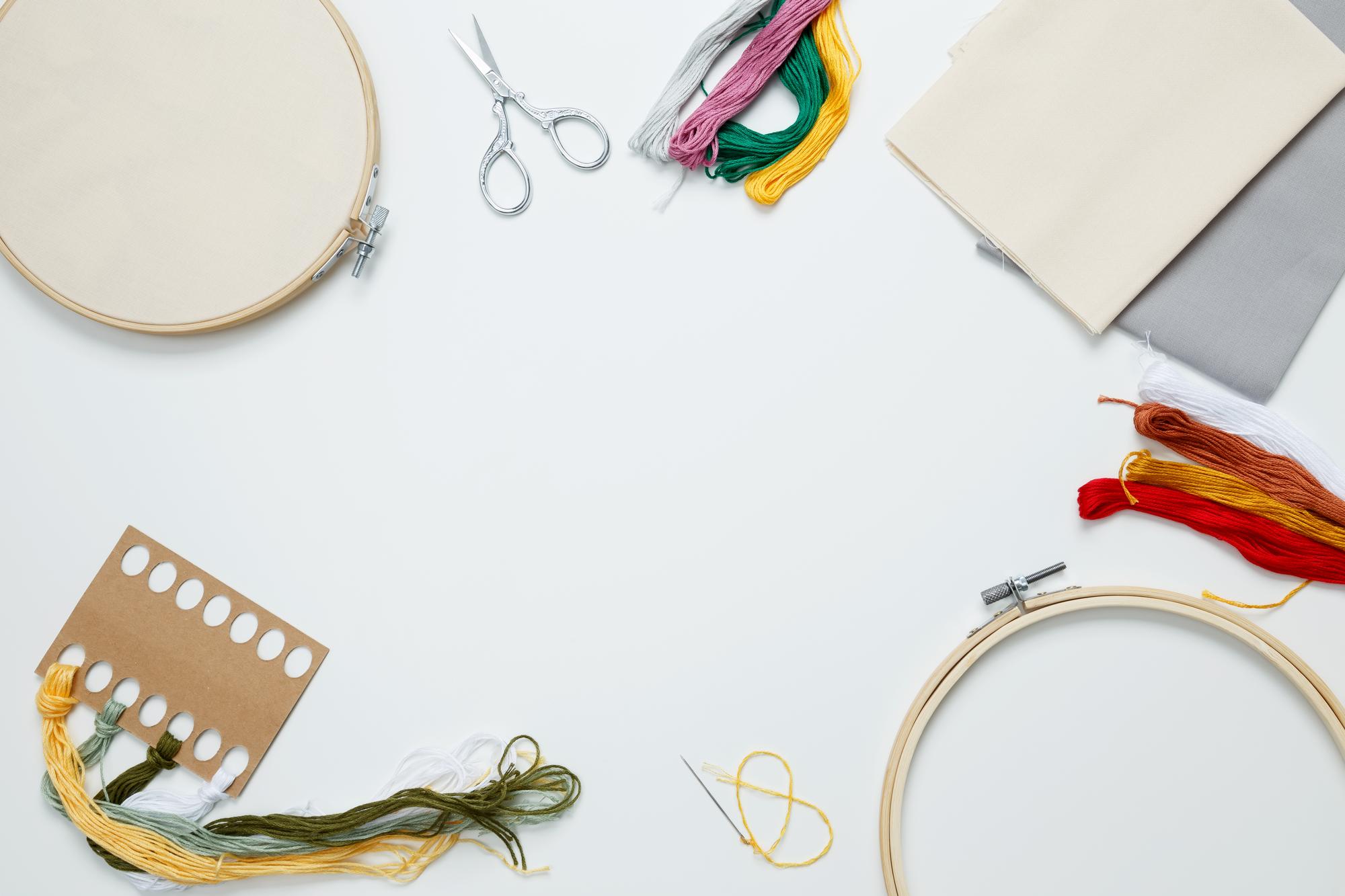 atelier workspace with thread spools and hoops